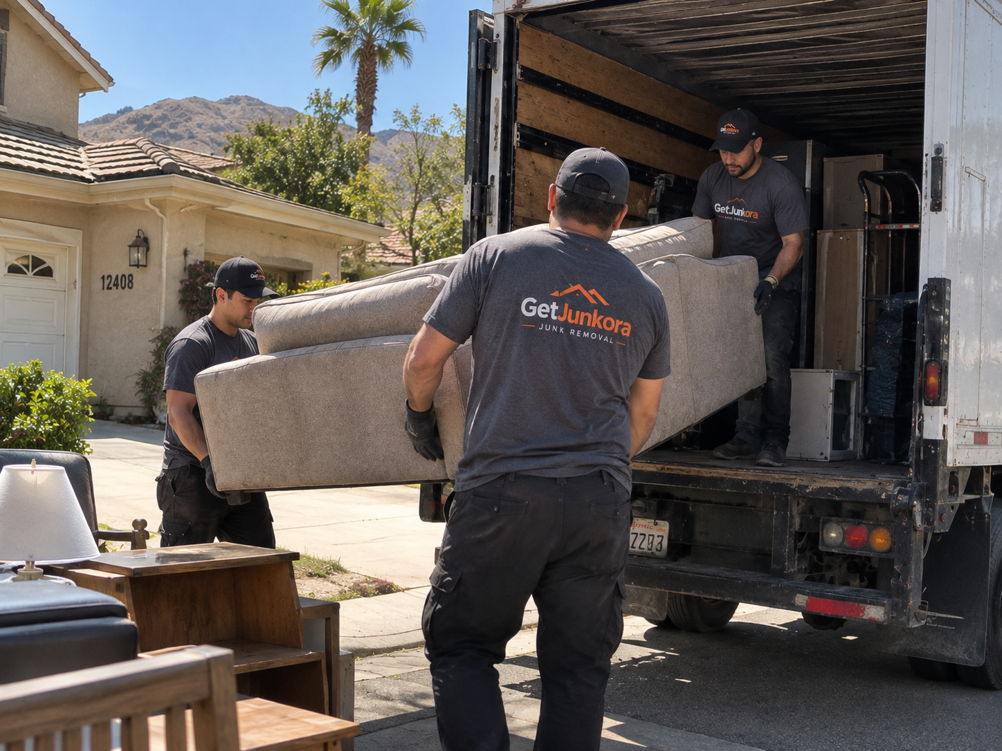 Professional junk removal crew loading items into a truck in sunny Southern California